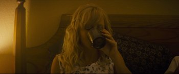 Movie still from “Synchronic” (2019), directed by Justin Benson – A woman is drinking a cup of coffee; Close Up shot, High angle