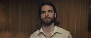 Movie still from “Synchronic” (2019), directed by Justin Benson – A man with long hair and a beard looking up; Close Up shot, Low angle