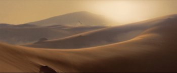Movie still from “Synchronic” (2019), directed by Justin Benson – The sun is setting over a desert landscape; Extreme Wide shot, High angle