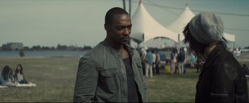 Movie still from “Synchronic” (2019), directed by Justin Benson – A man standing in front of a group of people; Medium shot, Over the shoulder angle