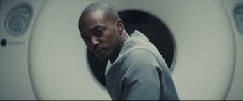 Movie still from “Synchronic” (2019), directed by Justin Benson – A black man in a gray sweatshirt is looking at the camera; Close Up shot, Low angle