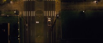 Movie still from “Synchronic” (2019), directed by Justin Benson – An aerial view of a car driving down the street; Extreme Wide shot, Overhead angle