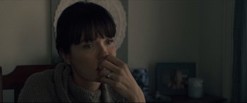 Movie still from “Synchronic” (2019), directed by Justin Benson – A woman with her hand to her face; Close Up shot, Over the shoulder angle