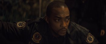 Movie still from “Synchronic” (2019), directed by Justin Benson – A person wearing a uniform; Close Up shot, High angle