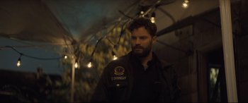 Movie still from “Synchronic” (2019), directed by Justin Benson – A man with a beard wearing a black jacket; Close Up shot, Over the shoulder angle