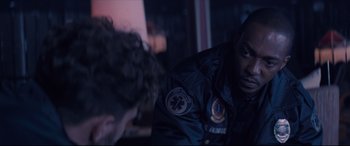 Movie still from “Synchronic” (2019), directed by Justin Benson – A man wearing a jacket with a star on the back of it; Close Up shot, Over the shoulder angle
