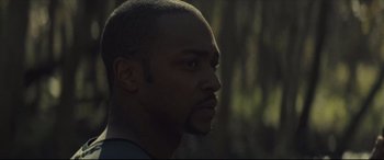 Movie still from “Synchronic” (2019), directed by Justin Benson – A person looking to his left; Close Up shot, Low angle