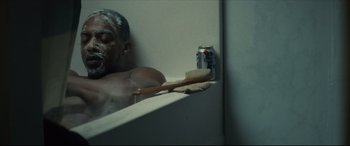 Movie still from “Synchronic” (2019), directed by Justin Benson – A man in a bath tub next to a can of soda and a brush; Close Up shot, Low angle