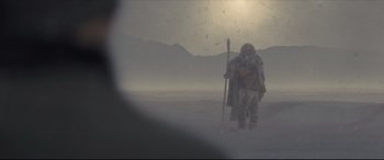 Movie still from “Synchronic” (2019), directed by Justin Benson – An image of an old man with a stick in the fog; Wide shot, Low angle