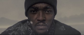Movie still from “Synchronic” (2019), directed by Justin Benson – A person wearing a hat; Extreme Close Up shot, Low angle