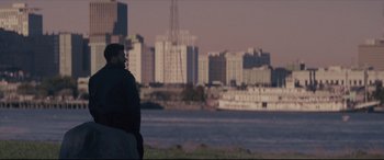 Movie still from “Synchronic” (2019), directed by Justin Benson – Two people standing on the shore of a body of water; Extreme Wide shot, Over the shoulder angle