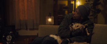 Movie still from “Synchronic” (2019), directed by Justin Benson – A man sitting on a couch next to a dog; Close Up shot, Over the shoulder angle