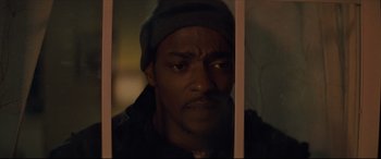 Movie still from “Synchronic” (2019), directed by Justin Benson – A person behind a fence; Close Up shot, Low angle