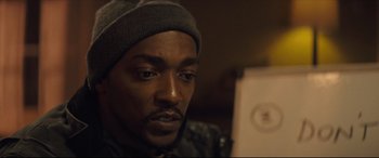 Movie still from “Synchronic” (2019), directed by Justin Benson – A person wearing a hat; Close Up shot, Over the shoulder angle