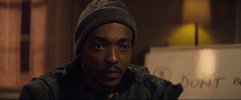 Movie still from “Synchronic” (2019), directed by Justin Benson – A person wearing a hat; Close Up shot, High angle