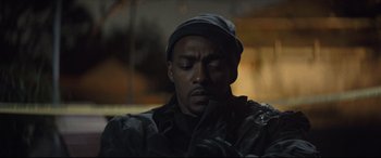 Movie still from “Synchronic” (2019), directed by Justin Benson – A man in a black jacket and a black hat; Close Up shot, Low angle
