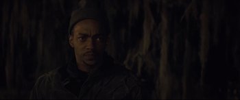 Movie still from “Synchronic” (2019), directed by Justin Benson – A person wearing a jacket and a hat; Close Up shot, Low angle