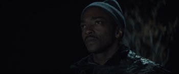 Movie still from “Synchronic” (2019), directed by Justin Benson – A person wearing a hat; Close Up shot, Low angle