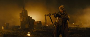 Movie still from “Synchronic” (2019), directed by Justin Benson – An old man is holding a rifle in the dark; Medium shot, Low angle