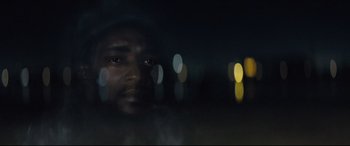 Movie still from “Synchronic” (2019), directed by Justin Benson – A man is looking out a window at night; Extreme Close Up shot, Low angle