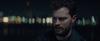 Movie still from “Synchronic” (2019), directed by Justin Benson – A person wearing a black shirt; Close Up shot, Over the shoulder angle