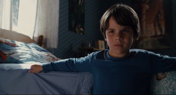 Movie still from “Ted” (2012), directed by Seth MacFarlane – A young boy sitting on a bed in a room; Close Up shot, High angle