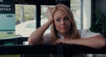 Movie still from “Ted” (2012), directed by Seth MacFarlane – A beautiful blond woman sitting in a restaurant; Close Up shot, Over the shoulder angle