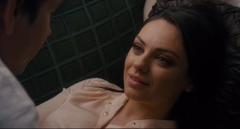 Movie still from “Ted” (2012), directed by Seth MacFarlane – A beautiful young lady sitting on top of a couch; Close Up shot, Overhead angle
