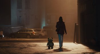 Movie still from “Ted” (2012), directed by Seth MacFarlane – A woman walking down a street with a teddy bear; Wide shot, Low angle