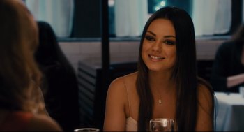 Movie still from “Ted” (2012), directed by Seth MacFarlane – A beautiful young lady sitting at a dinner table; Close Up shot, Over the shoulder angle