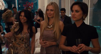 Movie still from “Ted” (2012), directed by Seth MacFarlane – A group of women standing next to each other holding wine glasses; Medium shot, Over the shoulder angle