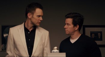 Movie still from “Ted” (2012), directed by Seth MacFarlane – A couple of men standing next to each other; Close Up shot, Over the shoulder angle
