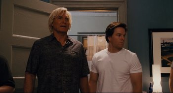 Movie still from “Ted” (2012), directed by Seth MacFarlane – Two men standing next to each other in front of a door; Medium shot, Low angle