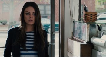 Movie still from “Ted” (2012), directed by Seth MacFarlane – A woman standing in front of an open door; Close Up shot, Over the shoulder angle