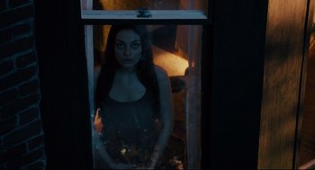 Movie still from “Ted” (2012), directed by Seth MacFarlane – A woman standing in front of an open window; Medium shot, High angle