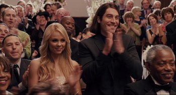 Movie still from “Ted” (2012), directed by Seth MacFarlane – A man and a woman clapping in front of an audience; Medium shot, Over the shoulder angle