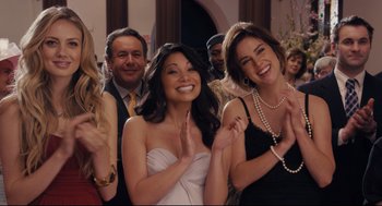 Movie still from “Ted” (2012), directed by Seth MacFarlane – A group of people standing next to each other in a room; Medium shot, Over the shoulder angle