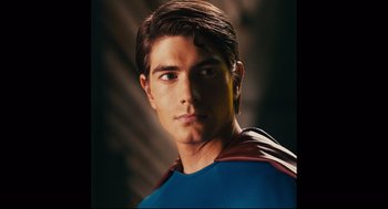 Movie still from “Ted” (2012), directed by Seth MacFarlane – A young man in a superman costume is posing for a picture; Close Up shot, Low angle