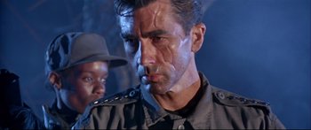 Movie still from “Terminator 2: Judgment Day” (1991), directed by James Cameron – A man that is looking at something in his face; Close Up shot, Low angle
