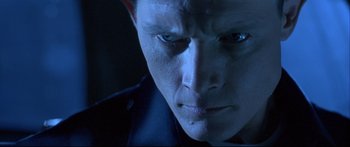 Movie still from “Terminator 2: Judgment Day” (1991), directed by James Cameron – A man's face in a dark room; Close Up shot, Low angle