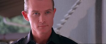 Movie still from “Terminator 2: Judgment Day” (1991), directed by James Cameron – A person wearing a black shirt; Close Up shot, Low angle