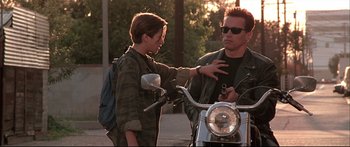 Movie still from “Terminator 2: Judgment Day” (1991), directed by James Cameron – A man and a woman on a motorcycle; Medium shot, Low angle