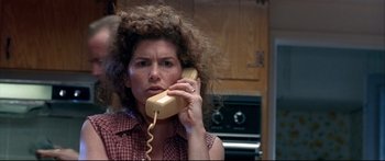 Movie still from “Terminator 2: Judgment Day” (1991), directed by James Cameron – A woman holding a phone up to her ear; Close Up shot, High angle