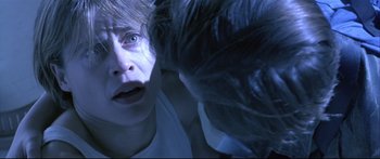 Movie still from “Terminator 2: Judgment Day” (1991), directed by James Cameron – A woman looking into a mirror with her eyes wide open; Close Up shot, Overhead angle