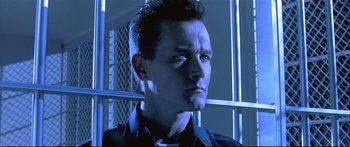 Movie still from “Terminator 2: Judgment Day” (1991), directed by James Cameron – A person wearing a black shirt; Close Up shot, Low angle
