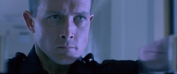 Movie still from “Terminator 2: Judgment Day” (1991), directed by James Cameron – A person's face in a dark room; Close Up shot, Low angle