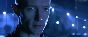 Movie still from “Terminator 2: Judgment Day” (1991), directed by James Cameron – A man's face in the dark; Close Up shot, Over the shoulder angle