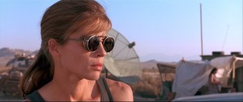 Movie still from “Terminator 2: Judgment Day” (1991), directed by James Cameron – A person wearing sunglasses near a satellite dish; Close Up shot, Low angle