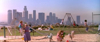 Movie still from “Terminator 2: Judgment Day” (1991), directed by James Cameron – A group of people in a field with a city in the background; Extreme Wide shot, High angle