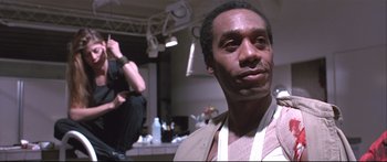 Movie still from “Terminator 2: Judgment Day” (1991), directed by James Cameron – A man in a brown shirt and a woman in a white shirt; Close Up shot, Low angle